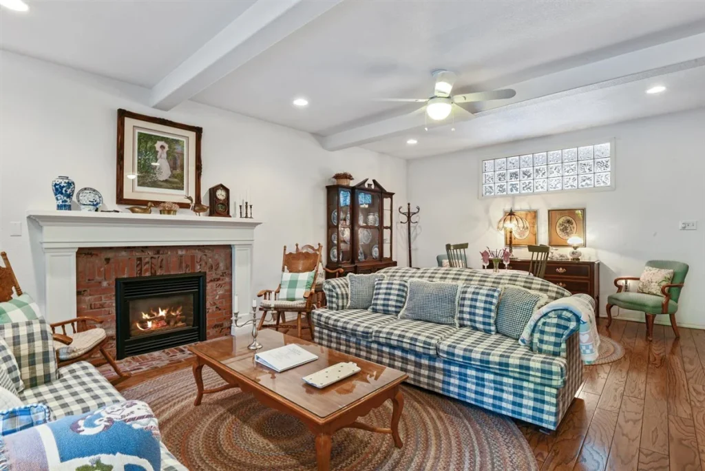 Abella Garden Inn living room with cozy couches and fireplace.